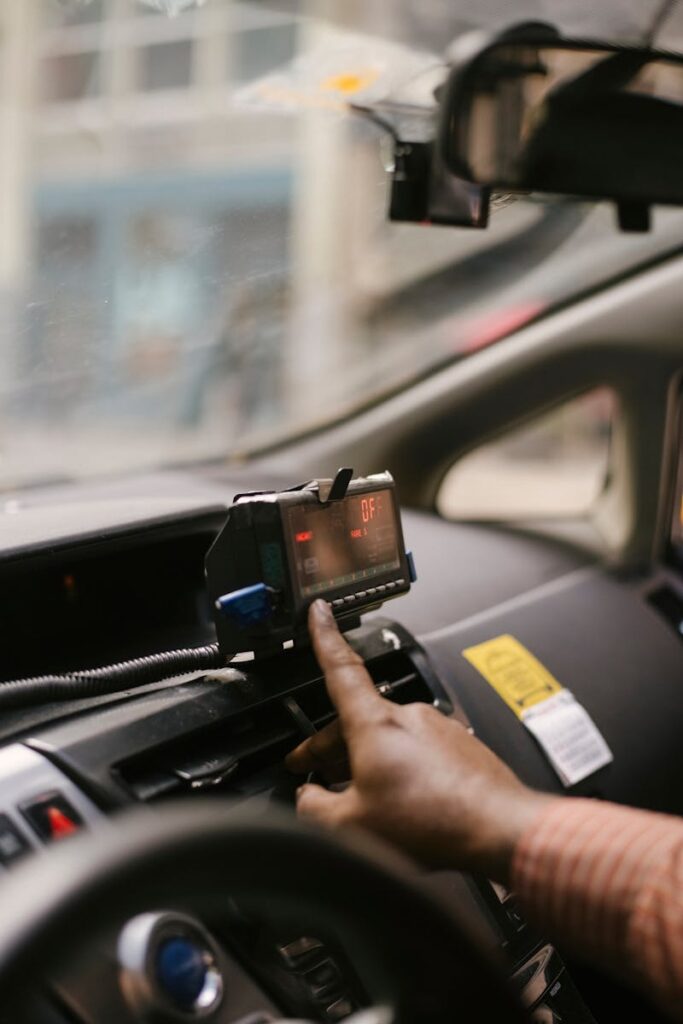 Crop ethnic man using GPS in cab