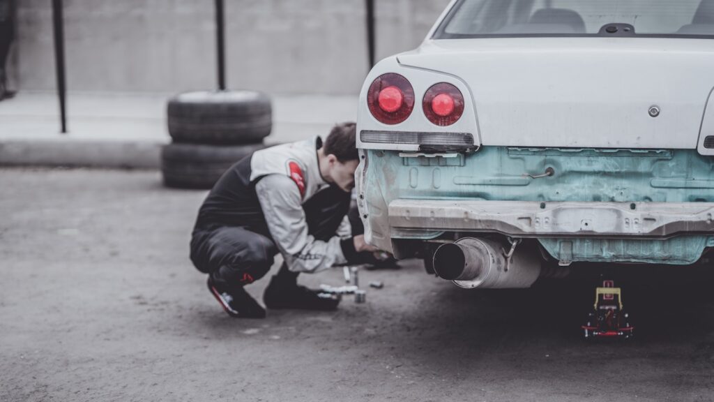 man fixing car